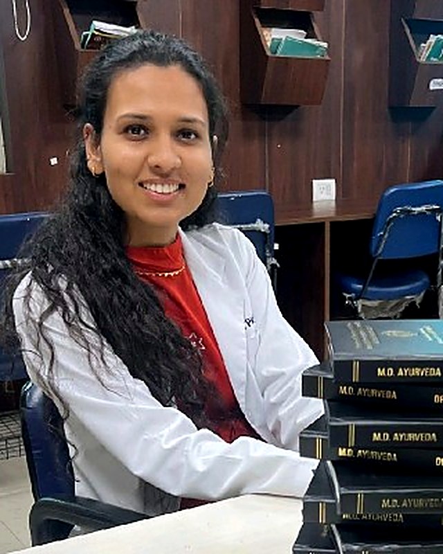 Prerna Sharma, Ayurvedic wellness consultant, with her M.D. Ayurveda thesis volumes